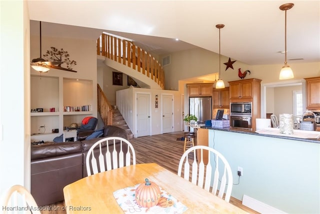 112 Wild Duck Pt, Lorida, FL 33857 - dining space featuring stairway, a ceiling fan, high vaulted ceiling, and wood finished floors