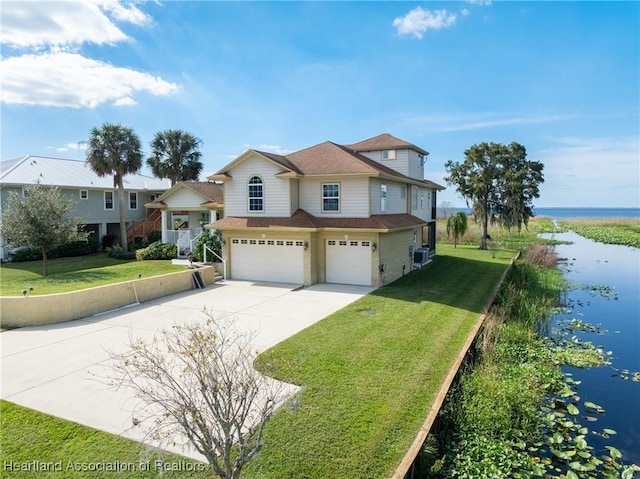 112 Wild Duck Pt, Lorida, FL 33857 - view of front of property with a water view, an attached garage, driveway, a front yard, and roof with shingles