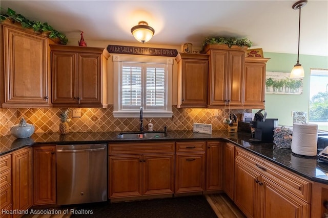 112 Wild Duck Pt, Lorida, FL 33857 - kitchen with stainless steel dishwasher, brown cabinets, tasteful backsplash, and pendant lighting