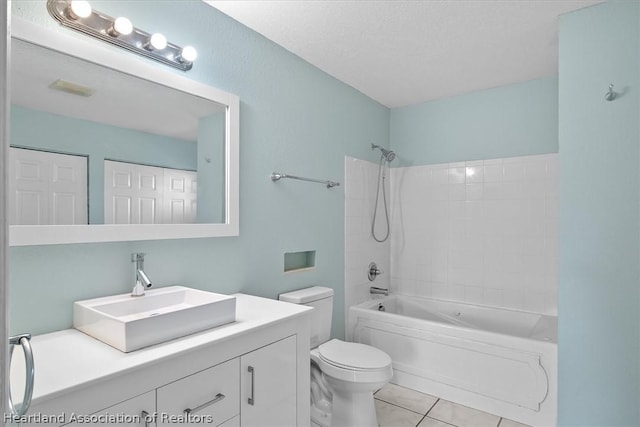 full bathroom with bathing tub / shower combination, tile patterned floors, a textured ceiling, toilet, and vanity