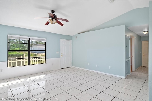 tiled spare room featuring ceiling fan and vaulted ceiling