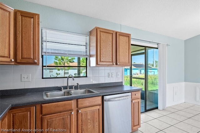 kitchen featuring dishwasher, decorative backsplash, sink, and a wealth of natural light