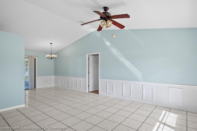 tiled empty room with ceiling fan with notable chandelier and vaulted ceiling