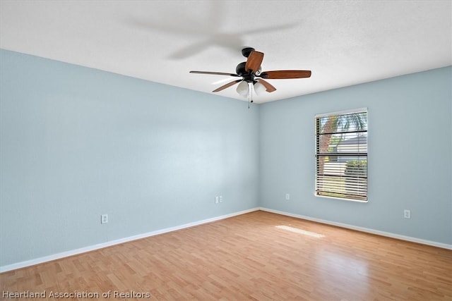 empty room featuring ceiling fan and hardwood / wood-style floors