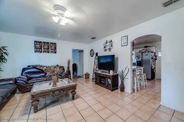 tiled living room featuring ceiling fan