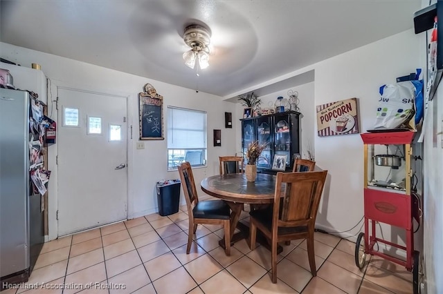 tiled dining room featuring ceiling fan