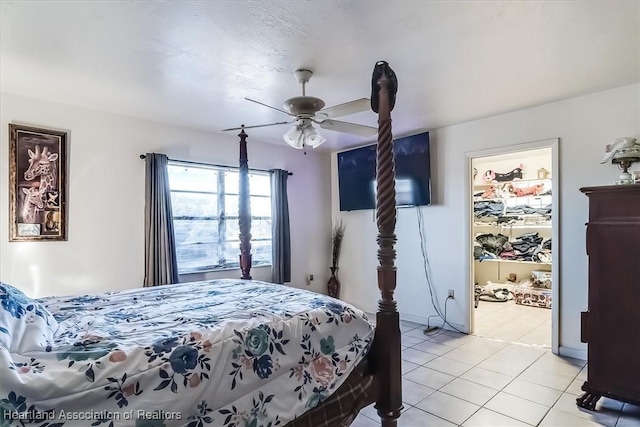 tiled bedroom featuring ceiling fan