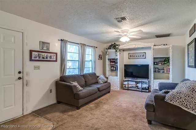 carpeted living room with ceiling fan and a textured ceiling