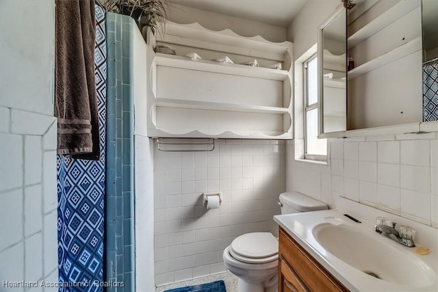 bathroom with a shower with curtain, vanity, toilet, and tile walls