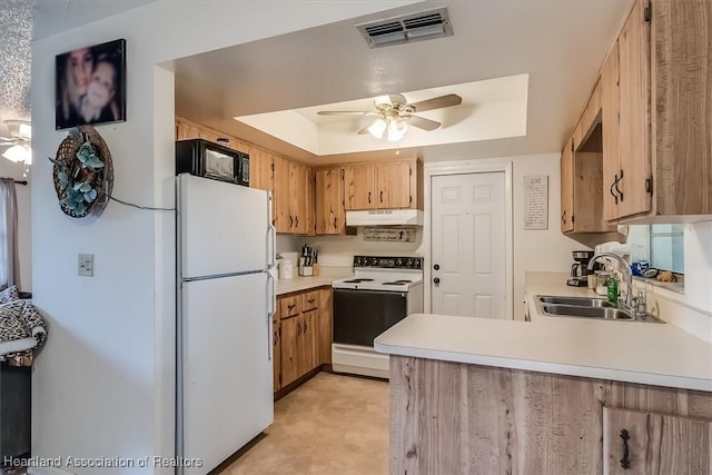 kitchen featuring sink, ceiling fan, kitchen peninsula, a raised ceiling, and white appliances