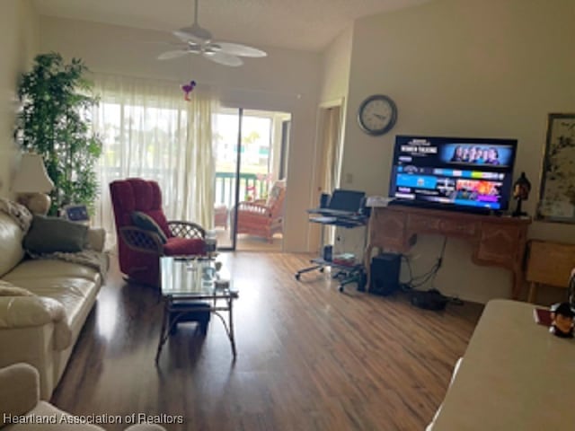 living room featuring ceiling fan and hardwood / wood-style floors