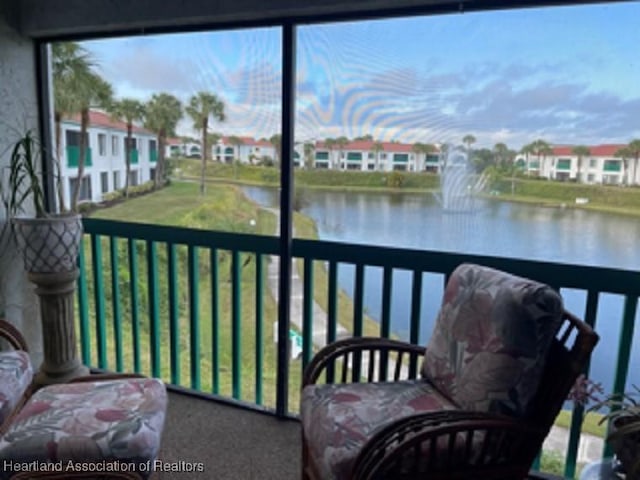 sunroom with a water view and a healthy amount of sunlight