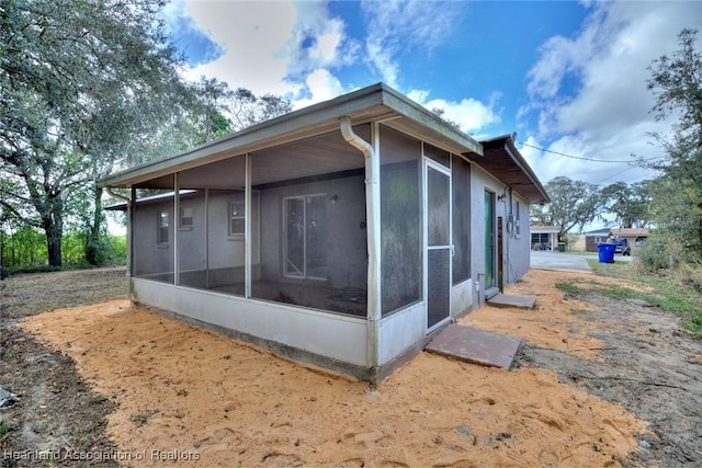 view of home's exterior with a sunroom