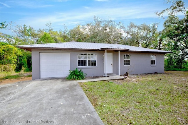 ranch-style home featuring a garage and a front lawn