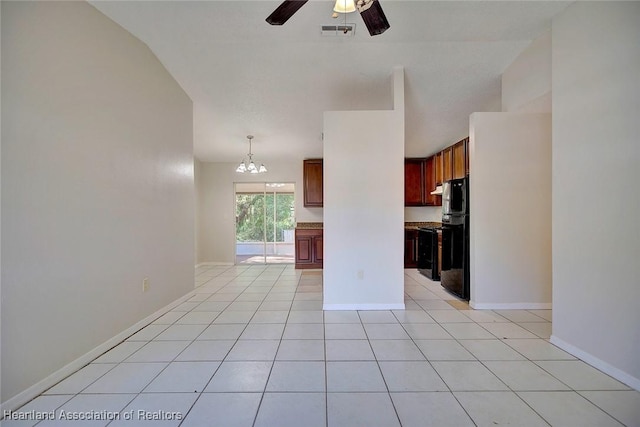 interior space featuring ceiling fan with notable chandelier, lofted ceiling, and light tile patterned flooring