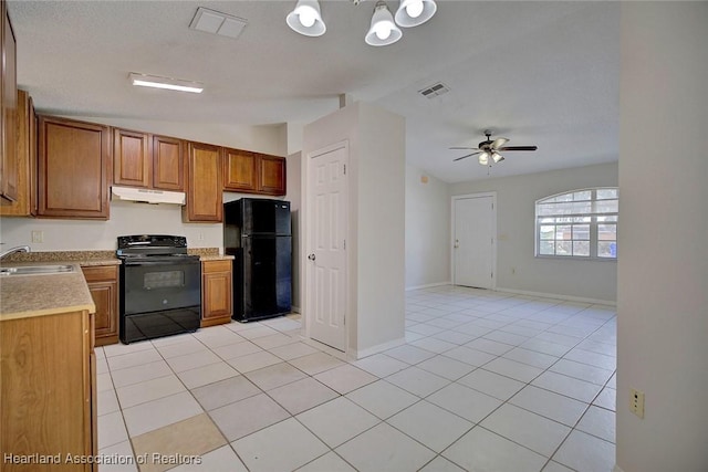 kitchen featuring black appliances, ceiling fan with notable chandelier, light tile patterned floors, and sink