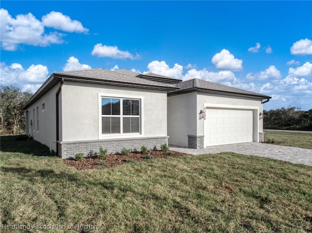 view of front of home featuring a garage and a front lawn