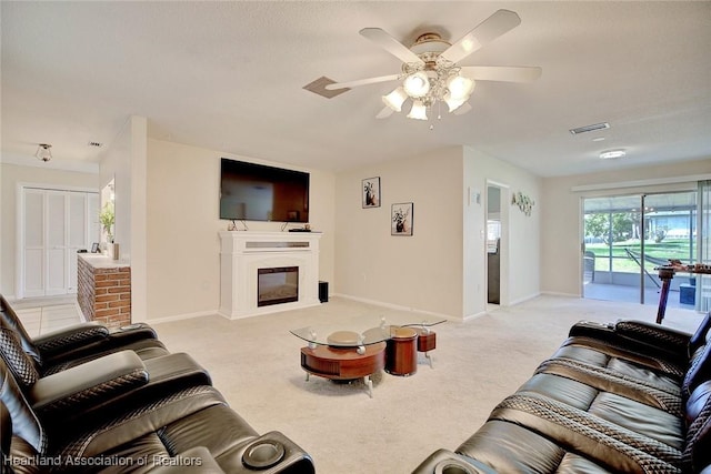 carpeted living room with ceiling fan