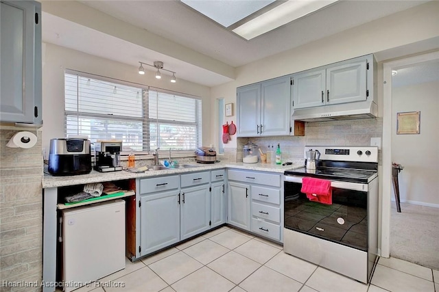 kitchen with backsplash, gray cabinetry, sink, light tile patterned floors, and electric range