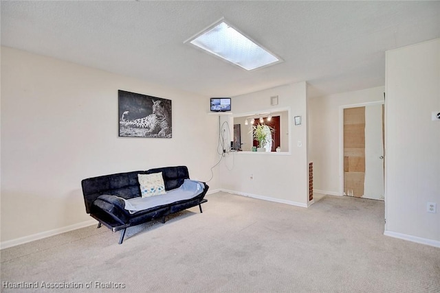 living area with a textured ceiling and light colored carpet