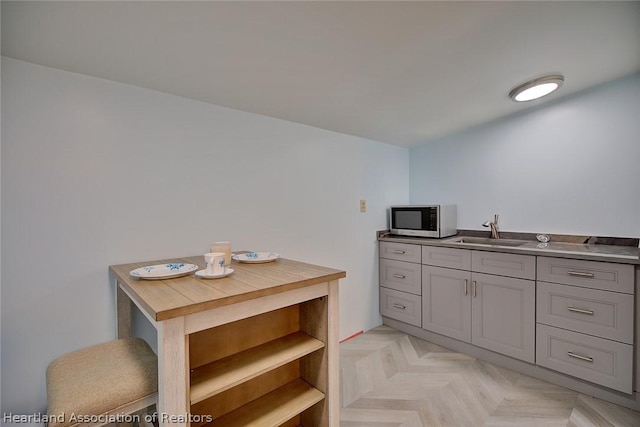 bathroom featuring sink and parquet flooring