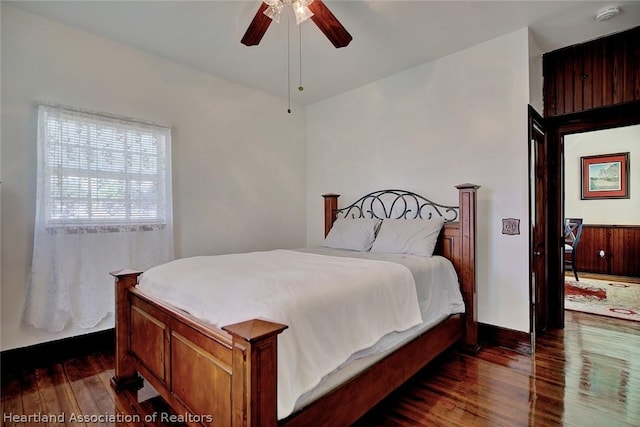 bedroom featuring ceiling fan and dark hardwood / wood-style floors