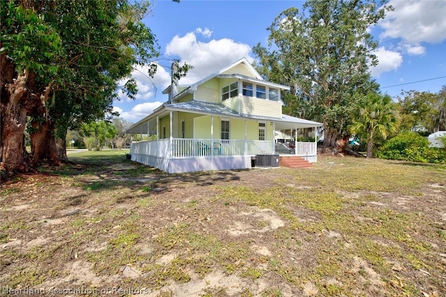 view of front of property with a porch and central AC unit