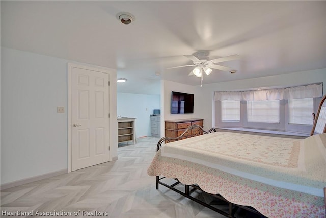 bedroom featuring ceiling fan and light parquet flooring