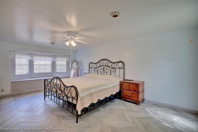 bedroom featuring ceiling fan and light parquet floors