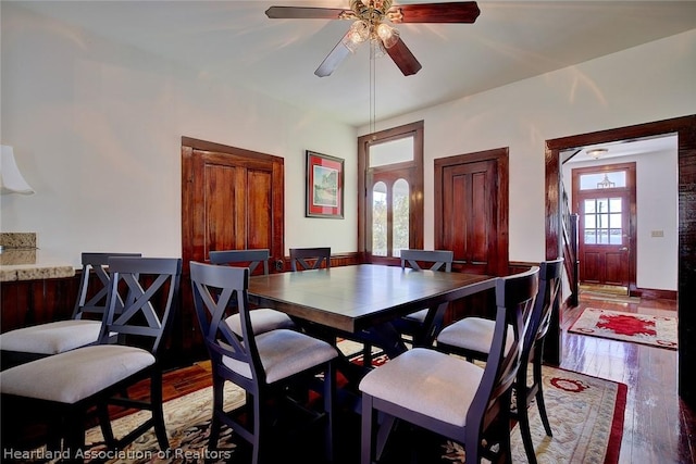 dining area featuring ceiling fan and wood-type flooring