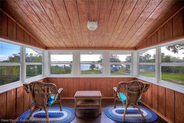 unfurnished sunroom with a water view, wooden ceiling, and lofted ceiling