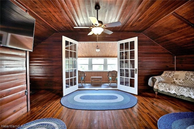 interior space featuring ceiling fan, vaulted ceiling, wood-type flooring, and french doors