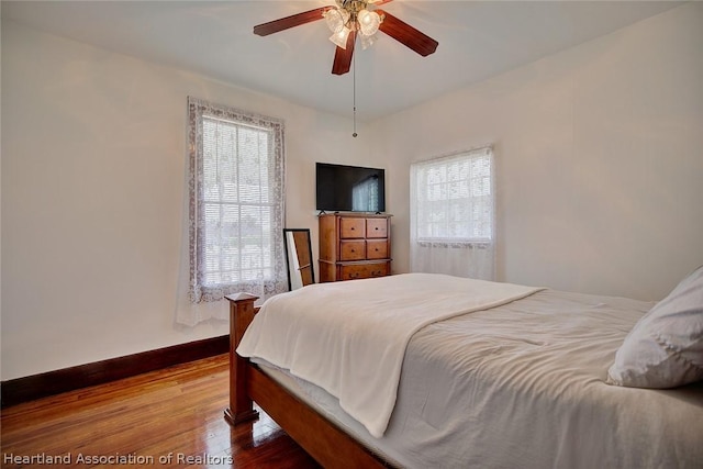 bedroom featuring hardwood / wood-style floors and ceiling fan