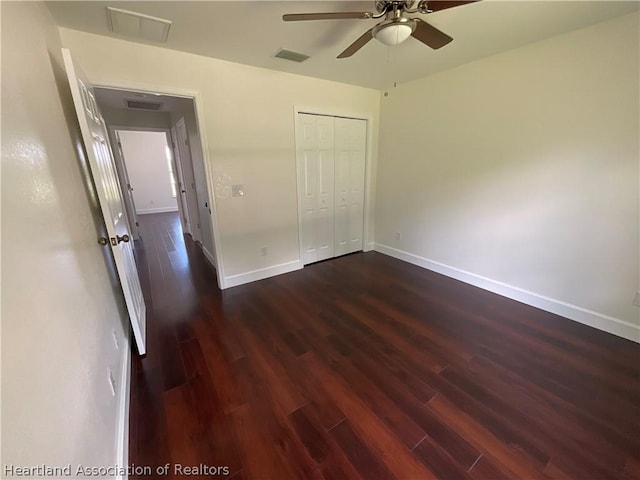 unfurnished bedroom featuring a closet, ceiling fan, and dark hardwood / wood-style floors