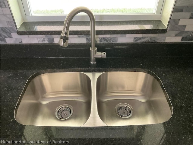 interior details featuring dark stone counters and sink