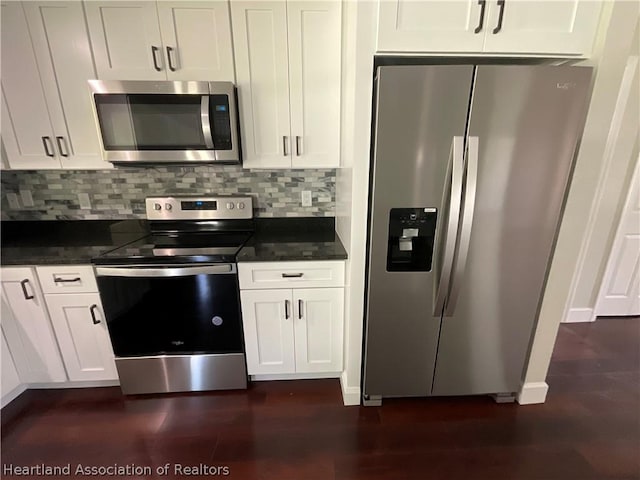 kitchen with tasteful backsplash, white cabinets, and appliances with stainless steel finishes