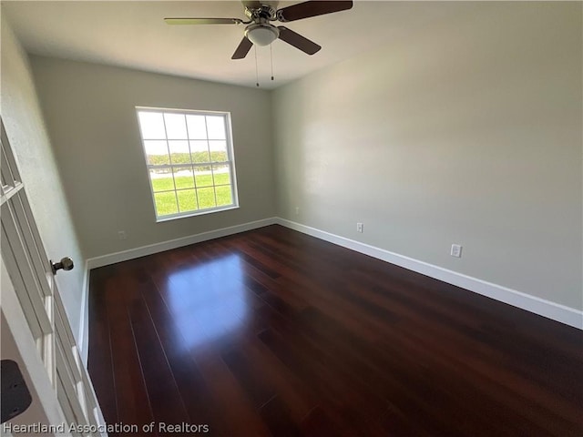 unfurnished room featuring ceiling fan and dark hardwood / wood-style flooring