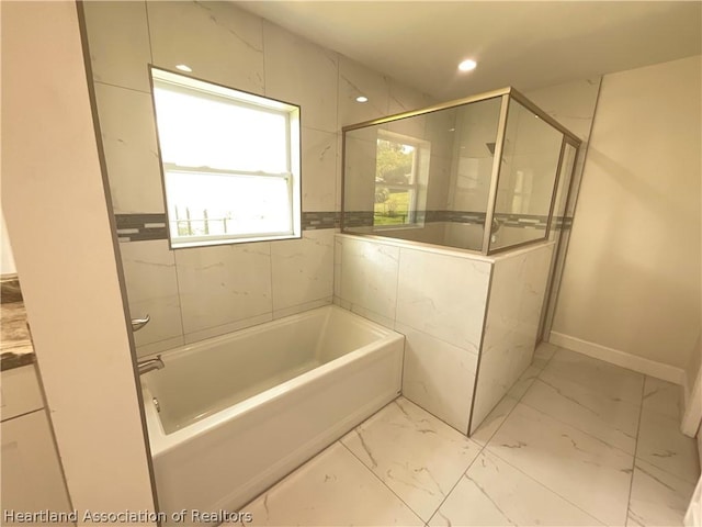 bathroom with separate shower and tub