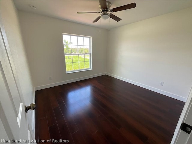 unfurnished room featuring ceiling fan and dark wood-type flooring