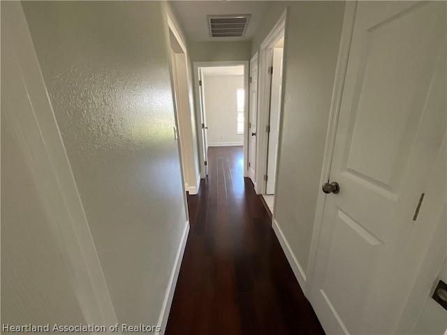 corridor featuring dark hardwood / wood-style floors