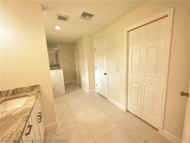 bathroom featuring vanity and an enclosed shower