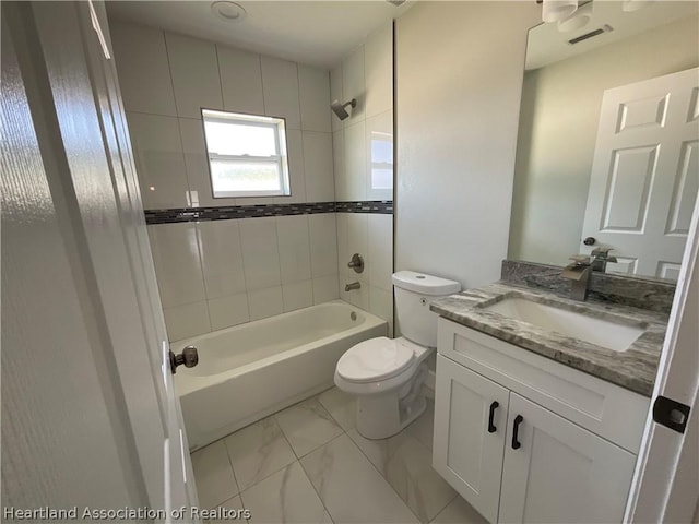 full bathroom featuring toilet, vanity, and tiled shower / bath