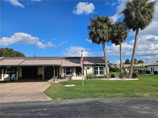 single story home featuring a carport and a front yard