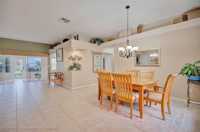 tiled dining space with a notable chandelier