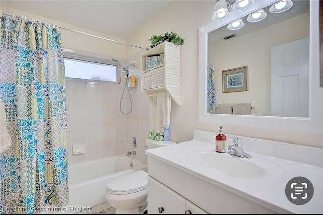 full bathroom with vanity, shower / bath combination with curtain, and toilet