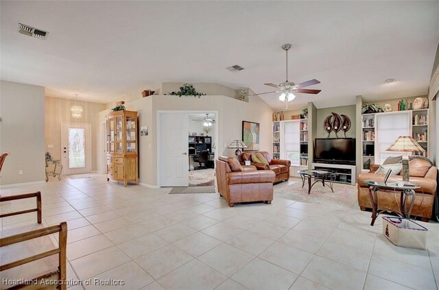 living room with vaulted ceiling, light tile patterned floors, and ceiling fan