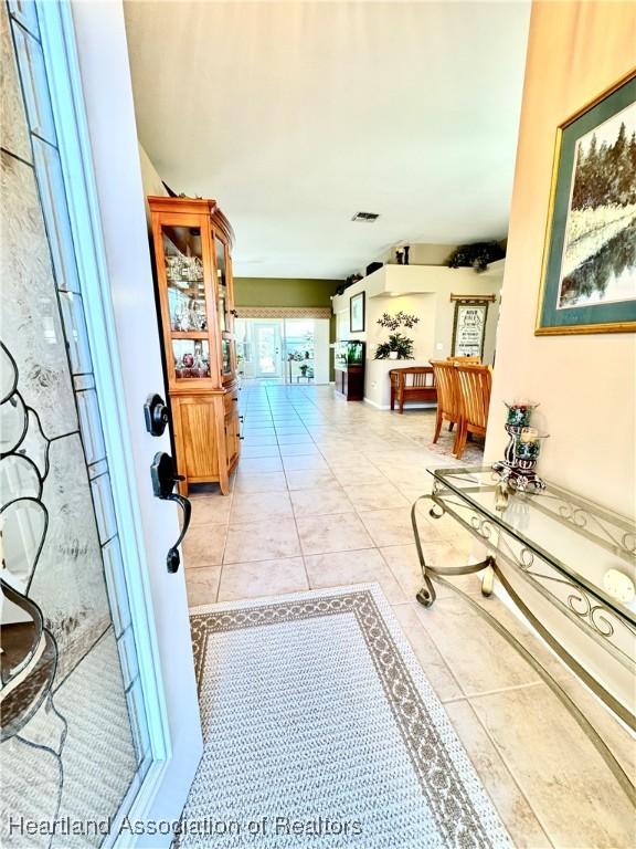 hall with light tile patterned floors