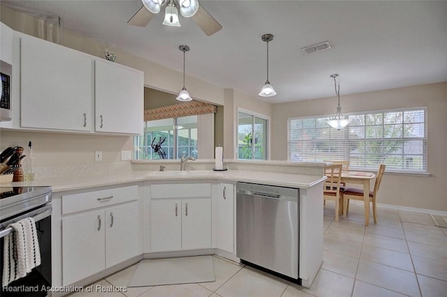 kitchen with hanging light fixtures, appliances with stainless steel finishes, and white cabinets