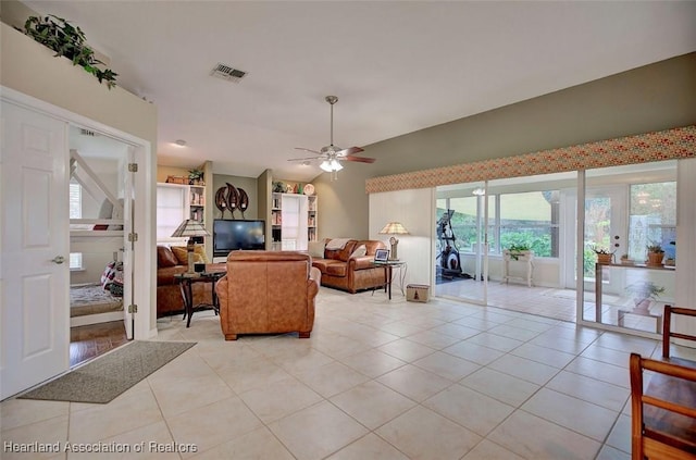 living room featuring french doors, ceiling fan, lofted ceiling, and light tile patterned floors