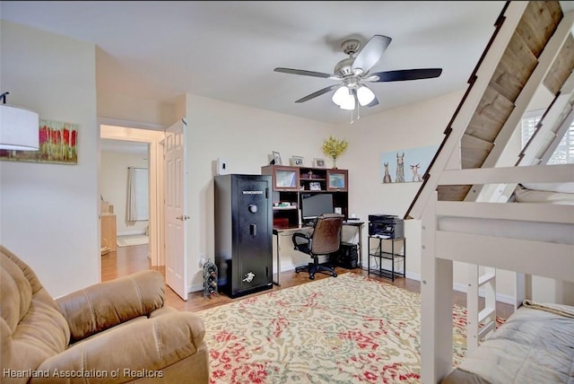 office area with light hardwood / wood-style floors and ceiling fan